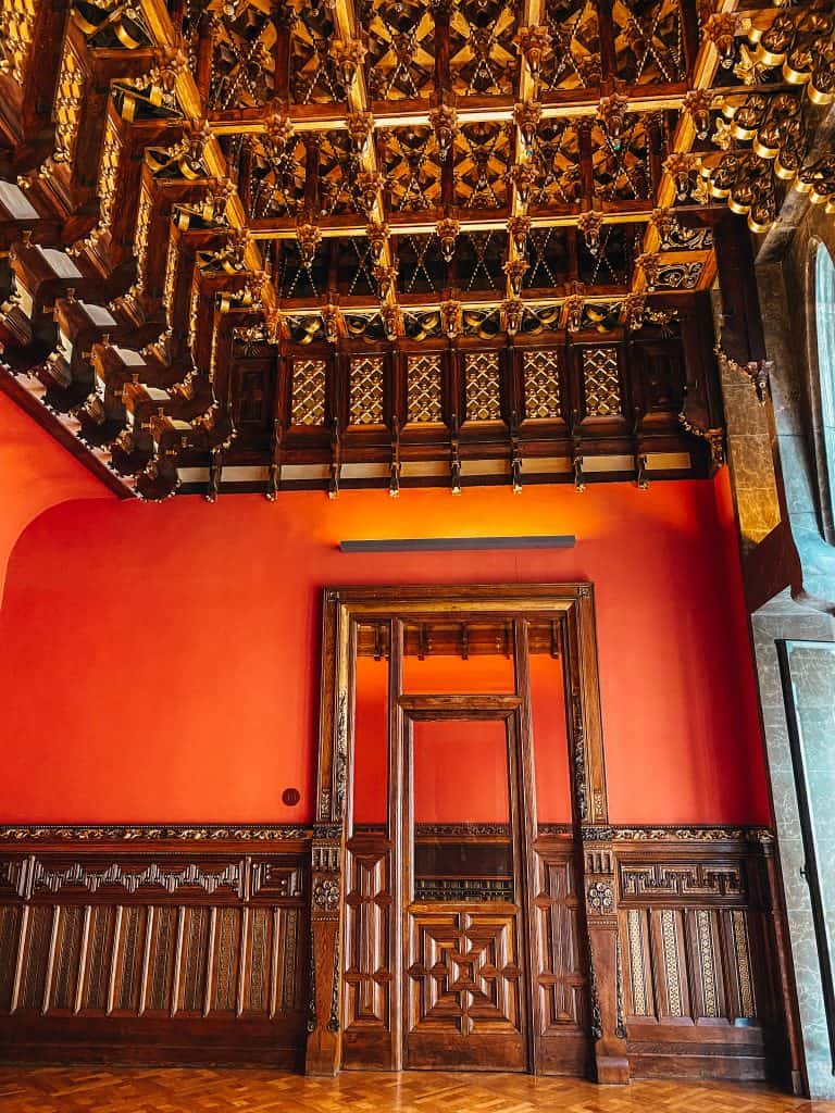 Room with red walls and a dark wooden roof