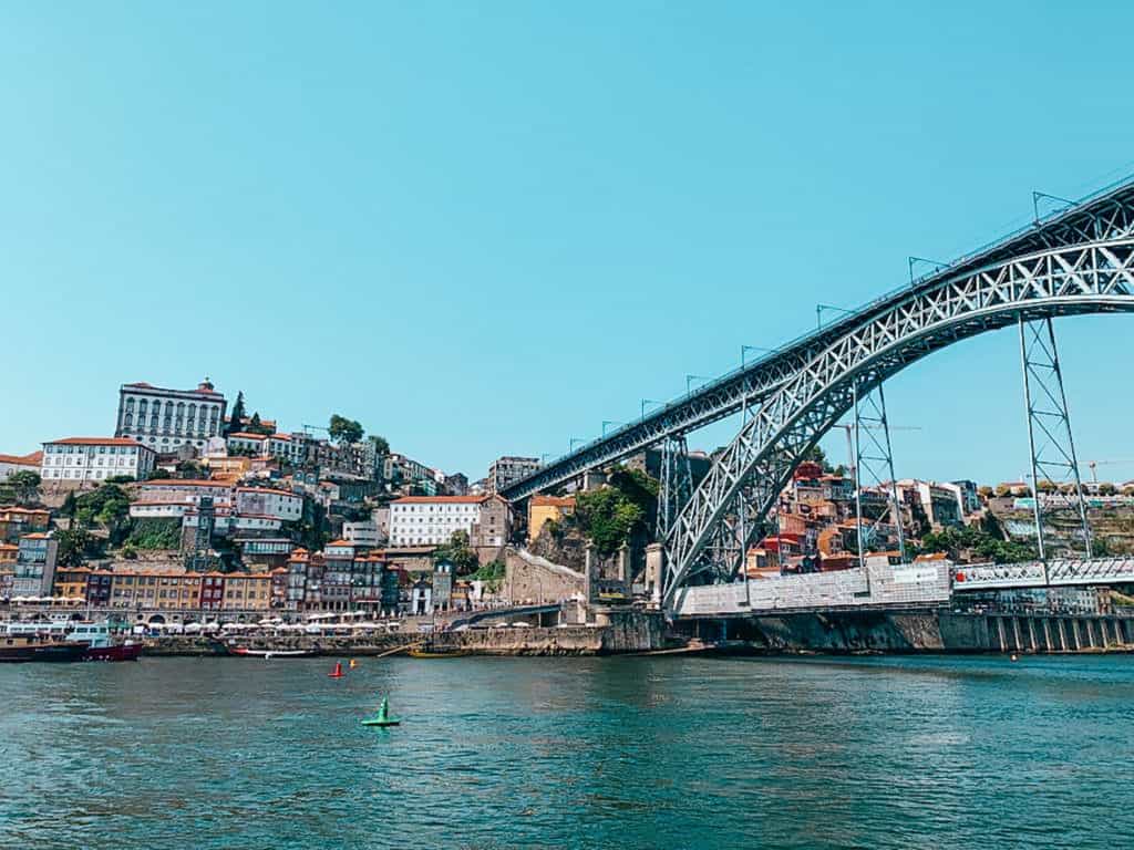 View of the old town of Porto and a steel bridge spanning a river, the best view of any 3 day Porto itinerary