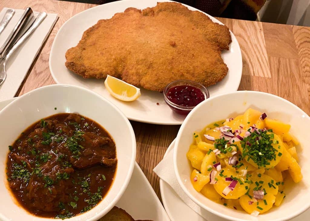 Wiener Schnitzel with potato salad and Gulasch at Velani, best vegan restaurants in Vienna