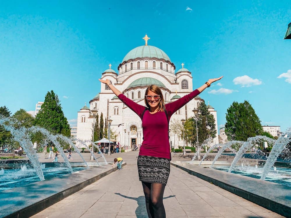 woman in front of Belgrade temple of St. Sava. Is Belgrade worth visiting? Yes if you want to see the countries largest church