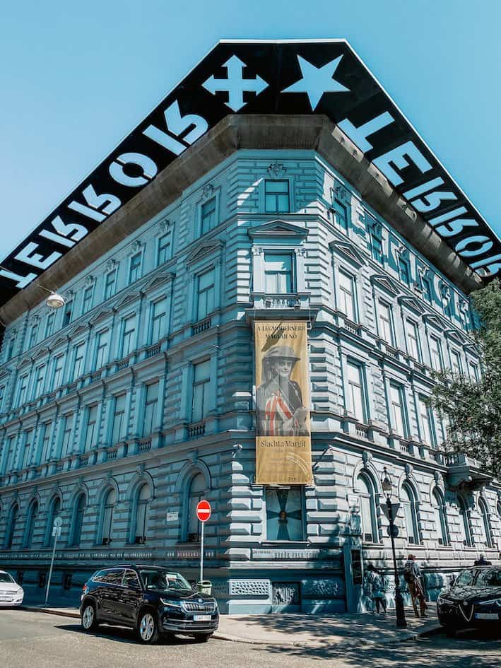 Building with a metal construction on the roof with the word "TERROR" cut out in Budapest