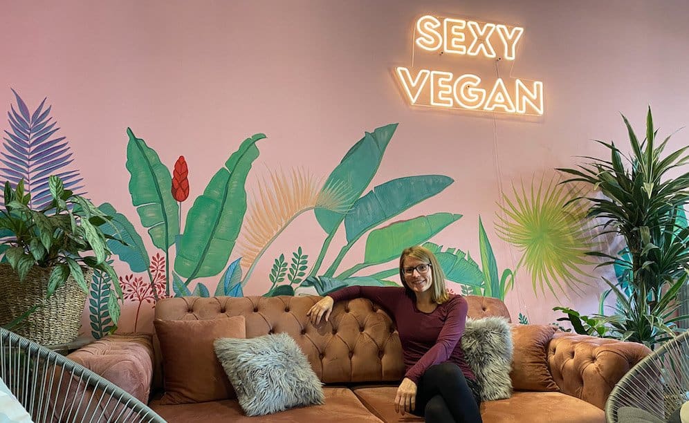 inside one of the vegan restaurants Belgrade, a woman is sitting on a couch