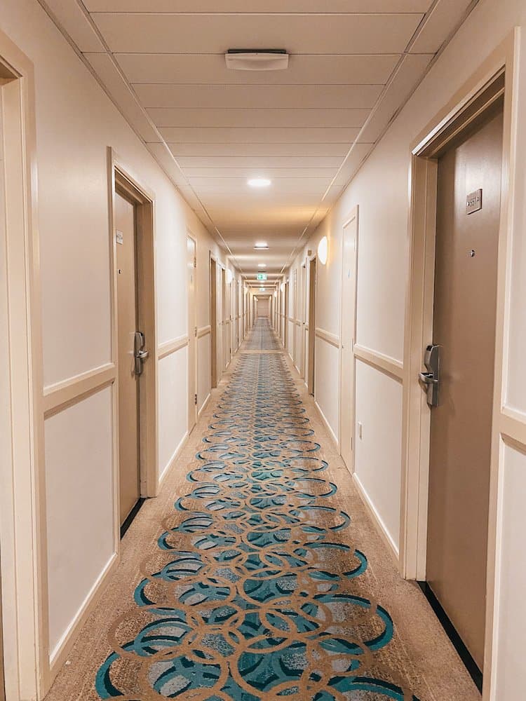 Long hotel hall with carpet floor