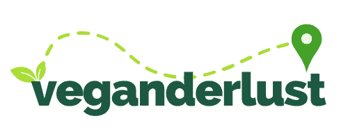 The word veganderlust with a leave and a location marker