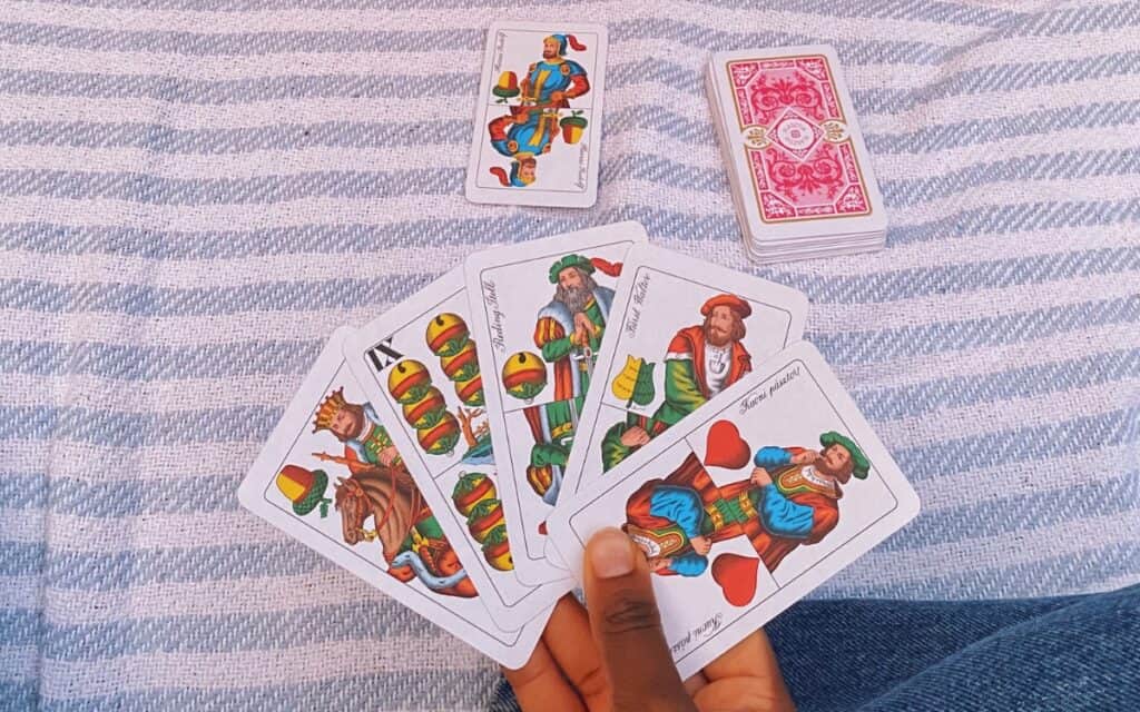 A hand holding playing cards
