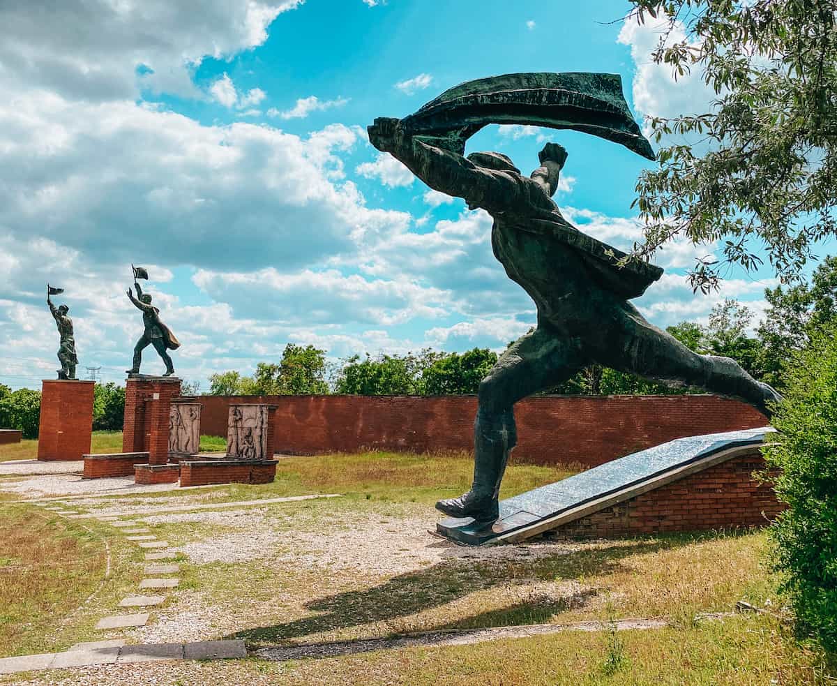 Three communist statues in a park in Budapest