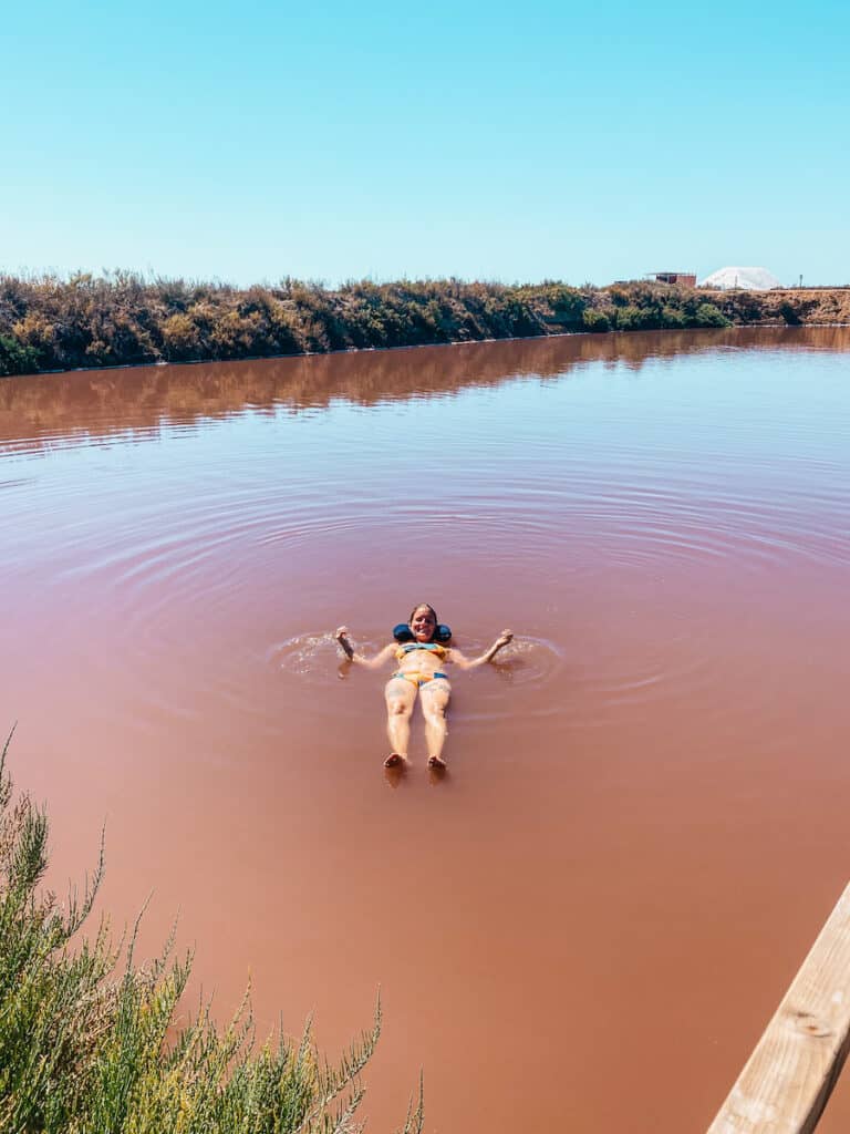 Tina floating in a salt lake  at Salinas do Grelha near Olhão
