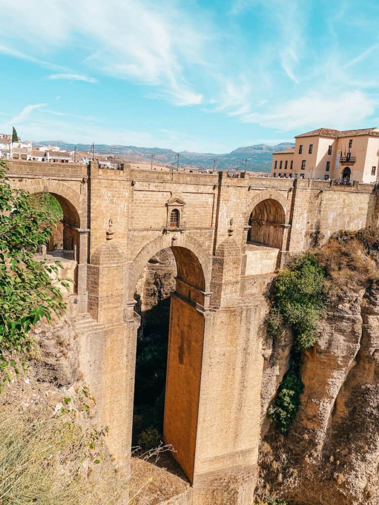 A massive bridge spanning a canyon in Ronda, which you can visit on a day trip from Seville to Ronda