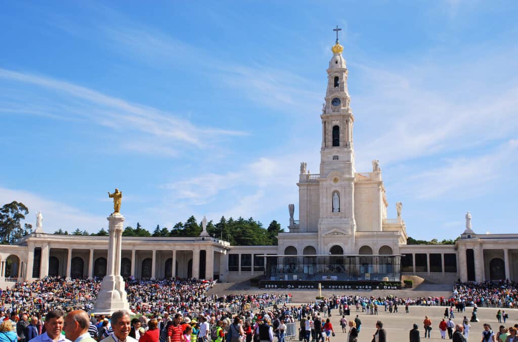 A big square with a church and a lot of people