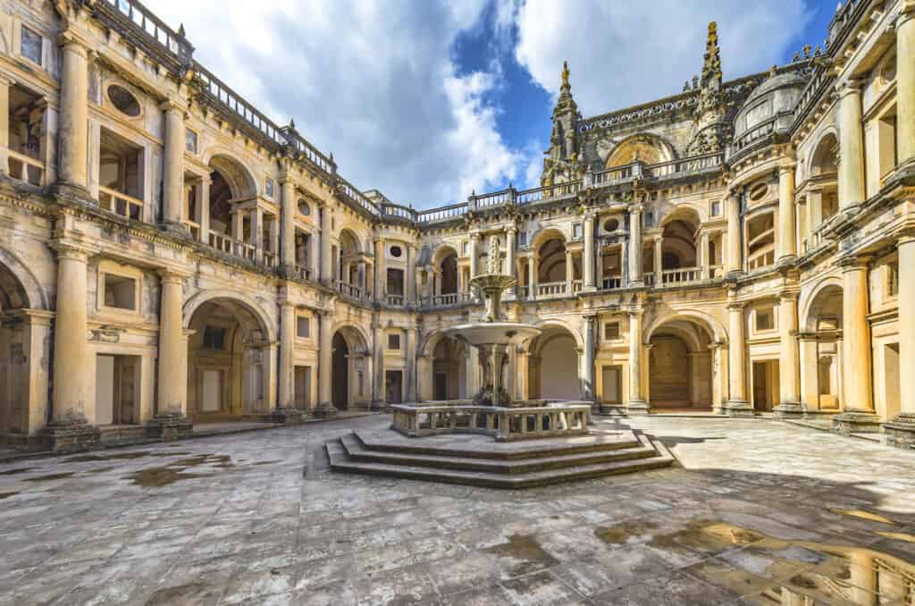 The courtyard of a yellow palace with intricate details in Tomar