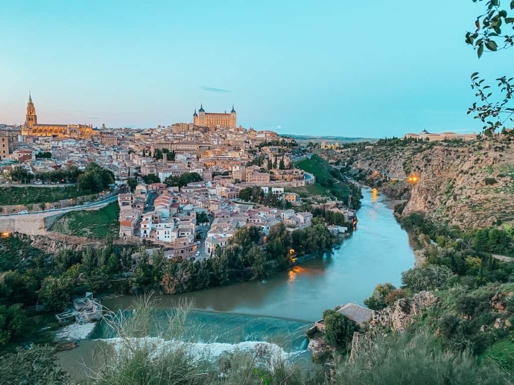 View of Toledo at sunset, a river goes past the town, on the other side of the river is nature