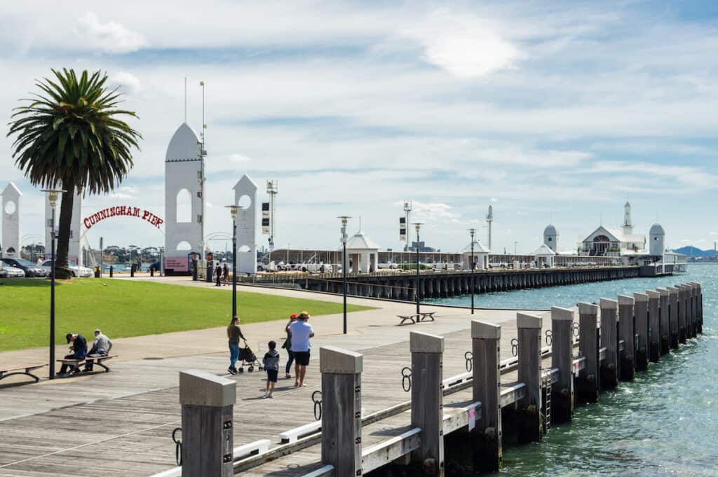 A pier with some people walking on it in Geelong near Melbourne