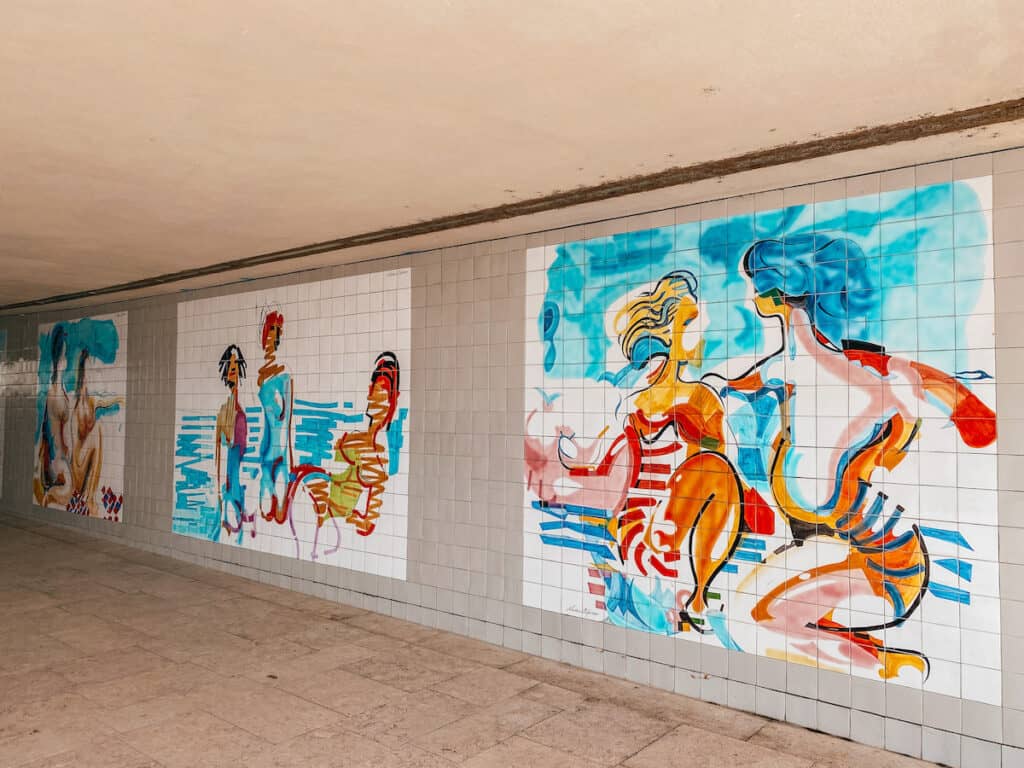 3 street art pictures next to each other, they portray bathing scenes in aquarelle colors