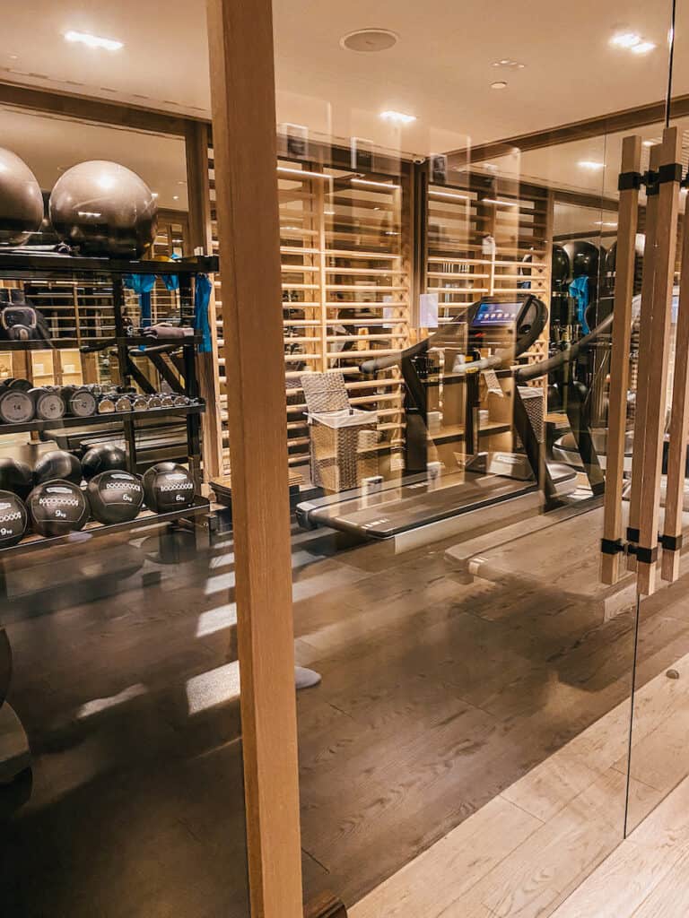 A small fitness room behind a glass wall
