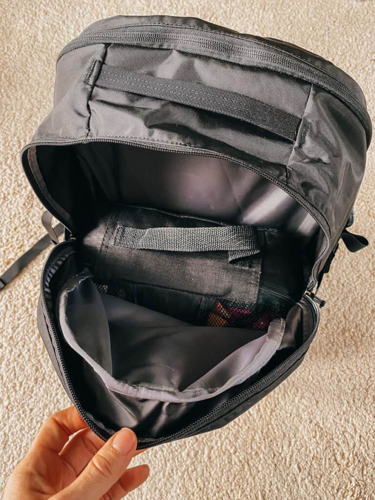 Open view of the interior of a Patagonia Refugio 26L backpack, revealing its ample storage and organizational compartments.