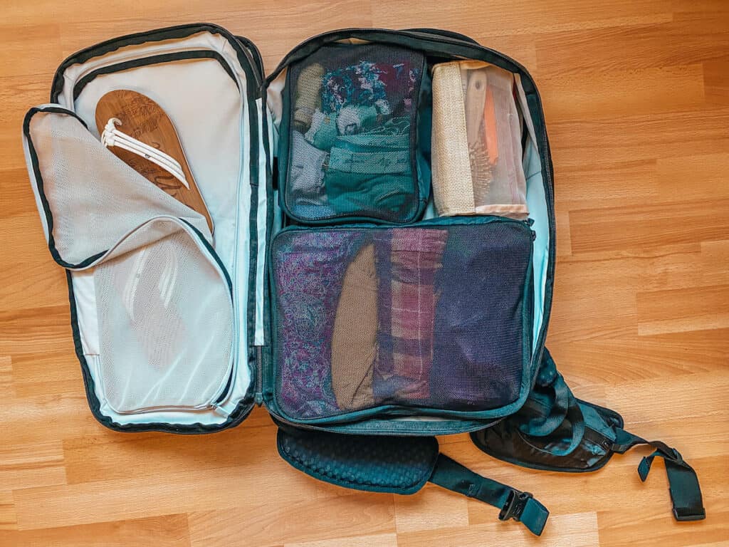 Inside view of an organized Tortuga 30L travel backpack, revealing the spacious compartments filled with travel essentials for a well-planned trip.