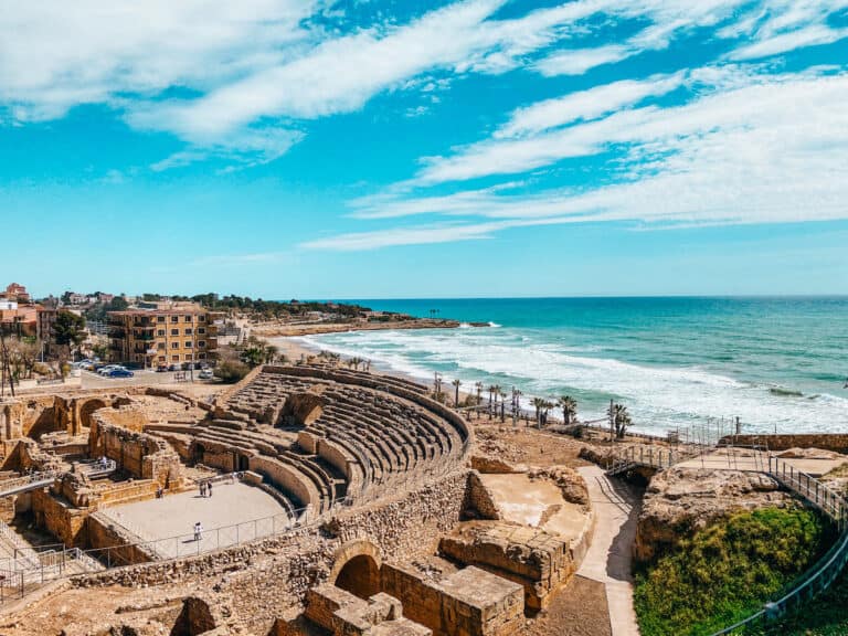 Ancient Roman Amphitheatre by the turquoise waters of the Mediterranean, a historic site to visit among the things to do in Tarragona Spain.