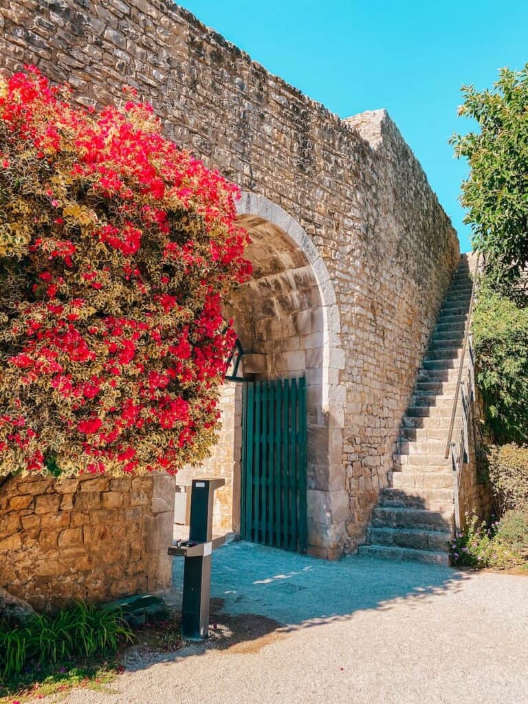 Strolling by the historic battlements draped with vibrant bougainvillea is an enchanting activity in Tavira, embodying Portugal's rich heritage.