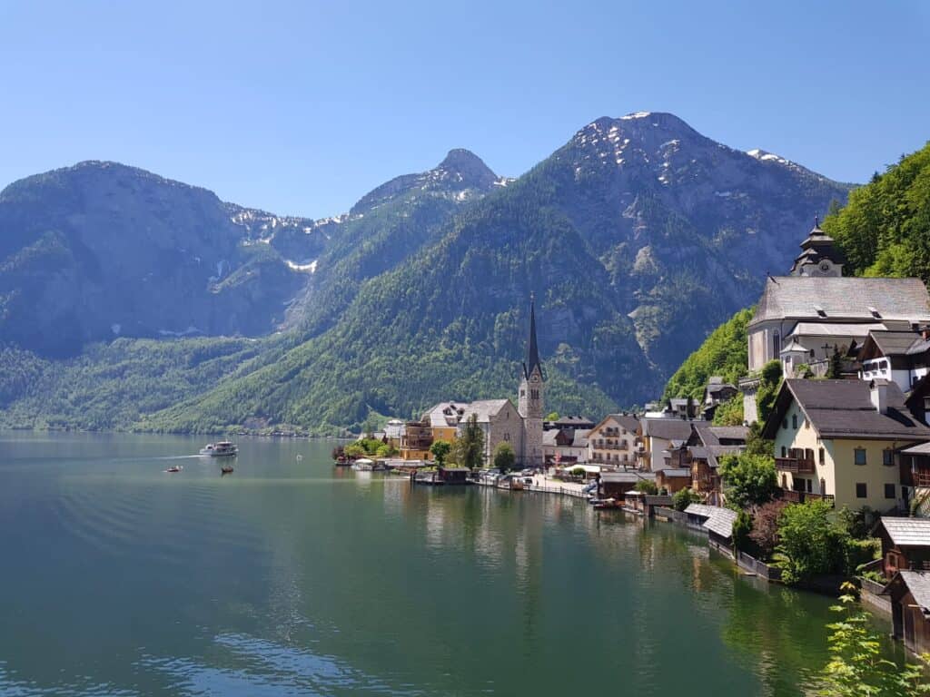 View of Hallstatt in Austria with mountains in the back, a small village next to a lake